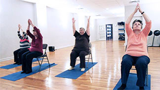 Seniors doing chair yoga